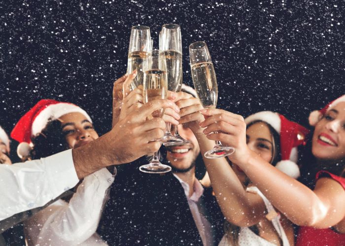 455786_adobestock_228707825_diverse-friends-clinking-with-champagne-glasses-on-new-years-eve